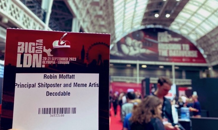 Conference badge that reads “Robin Moffatt: Principal Shitposter and Meme Artist”